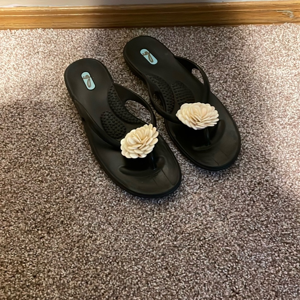 Oka Bee flip flops black in color size medium ML stamped on bottom of shoe